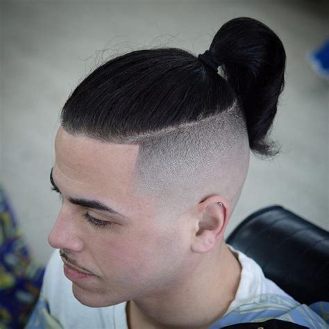 taper fade with ponytail|man ponytail with shaved sides.